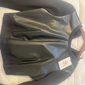 Long sleeve black blouse . Front it’s leather and nice stretch back.